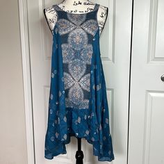 Blue Bohemian Mini Dress With Lace Trim, Bohemian Blue Mini Dress With Lace Trim, Blue Flowy Tunic Boho Dress, Blue Flowy Boho Tunic Dress, Blue Bohemian Mini Dress Knee-length, Blue Bohemian Knee-length Mini Dress, Blue Sleeveless Boho Dress For Spring, Spring Blue Sleeveless Boho Dress, Blue Bohemian Sleeveless Mini Dress