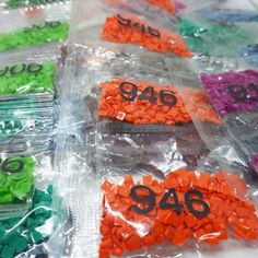 plastic bags filled with different colored numbers and letters on top of each other's sides