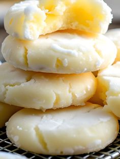 a pile of cookies sitting on top of a metal cooling rack covered in icing