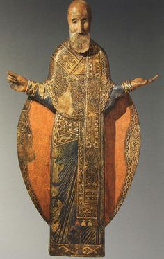 a wooden statue of a man with his arms outstretched