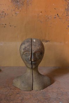 a clay head sitting on top of a wooden table