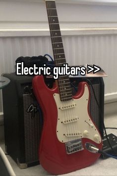 an electric guitar sitting on top of a table next to a speaker and amp with the words electric guitars > >