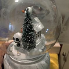 a snow globe with a christmas tree inside