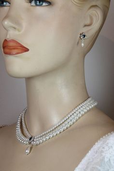 Amazing and stunning  bridal set of choker necklace and earrings for the bride features triple strands of white pearls and blue Sapphire Swarovski stone in the middle surrounded with clear Swarovski zirconium and dangling white vintage drop pearl below.This beautiful necklace can fit any style of white/ivory wedding dress.The shape is vintage Victorian and fits so beautiful on your neck. The earrings are extremely comfortable -  A perfect necklace and earrings for the bride or for another specia Luxury Pearl Bridal Necklace With Pearl Drop, Luxury Round Pearl Bridal Necklace, Luxury Bridal Necklace With Round Beads For Festive Occasion, Traditional Luxury Bridal Necklace With Polished Beads, Earing And Necklace Set For Wedding Pearl, Luxury Classic Bridal Necklace With Pearl Drop, Luxury Wedding Necklace With Round Beads, Luxury Pearl White Bridal Necklace With Round Beads, Luxury Wedding Beaded Necklace With Pearl Pendant