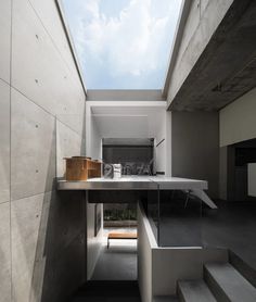 an empty room with stairs leading up to the top floor and skylight above it