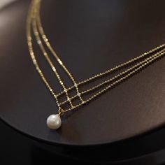 The 18K Gold Plated White Pearl Pendant Necklace for Women is a stunning and elegant piece of jewelry that exudes timeless beauty and sophistication. This necklace features a lustrous white pearl as its focal point, surrounded by a delicate and intricately designed 18K gold-plated pendant setting. This delicate pearl pendant necklace make for an elegant addition to any outfit. Classic jewelry vibe combined with the fashion-forward trend. Comfortable for daily wear, suitable for every occasion. Perfect Gift: This necklace will be a special gift for friends, wife, daughter, mother, sister, perfect gift for Christmas, Graduation, Birthday, Thanksgiving day, Valentine's Day Anniversary, Graduated Day, Mother's day. Material: Brass/18K Gold Plated/Pearl Size：23.0"+2.0"Extension Chain Color: Gol Elegant Gold Pearl Chain Necklace, Exquisite Gold Necklaces With Pearl Chain, Exquisite Gold Pearl Necklace With Pendant, Exquisite Gold Pearl Pendant Necklace, Elegant White Gold Pearl Necklace With Delicate Chain, Exquisite Gold Pearl Necklaces, Elegant Gold Pearl Necklace With Charm, Exquisite Gold Pearl Necklace With Elegant Design, Elegant Gold Pearl Drop Necklace