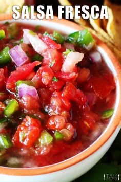 salsa in an orange and white bowl with tortilla chips on the side text reads salsa fresca