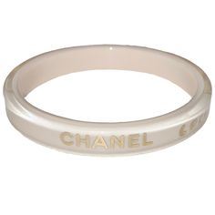 Authentic Chanel Coco Mademoiselle Cream Lucite Bangle Bracelet With Gold Inlaid Logo. Elegant Beige Bracelets For Formal Occasions, Elegant Beige Bracelet For Formal Occasions, Elegant Beige Bracelets, Luxury Beige Jewelry For Formal Occasions, Designer White Bangle Bracelets, Designer White Bangle Bracelet, Designer White Bracelets For Wedding, Adjustable White Bangle For Formal Occasions, Elegant Cream Bangle Bracelet