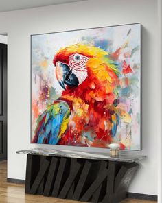 a large colorful parrot painting on the wall above a console table in a living room