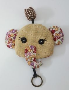 an elephant head is hanging on the wall with a keychain attached to it