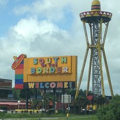 a large sign that says south border welcomes people to the town and is next to a water tower