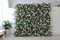 a wall covered in pink and white flowers