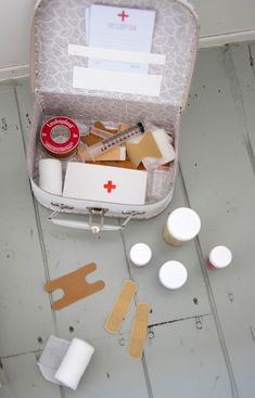 an open suitcase filled with medical supplies on the floor