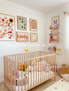 a baby crib in a child's room with pictures on the wall