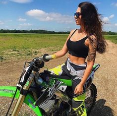 a woman sitting on top of a dirt bike