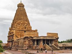 an ancient temple with people walking around it