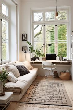 a living room filled with furniture and lots of windows