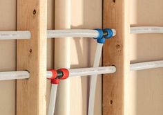 pipes are attached to the side of a wooden wall in order to keep water cool