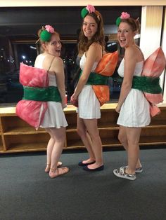 three girls dressed in costumes standing next to each other