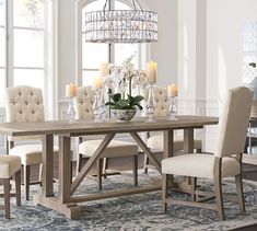 a dining room table with chairs and a chandelier