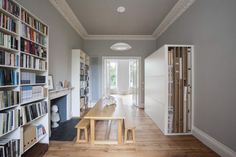 a long table in the middle of a room with bookshelves on both sides