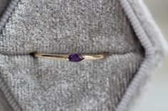 "A dainty marquise amethyst is at the center of our \"Wink\" ring, giving you just a little wink of sparkle! - Marquise stone measures 4mm x 2mm - Handcrafted out of 14K yellow, rose, or white gold - Round band measures 1.2mm in width Processing Times - Current processing time is 1 - 3 weeks. Each Item is handmade to order with love and care! In Stock Items - Contact Liesel Love with any rush order questions, or to see if we have anything ready made and in stock. Returns - Liesel Love does take Heirloom Marquise Birthstone Ring As Gift, Marquise Gemstone Stackable Promise Rings, Marquise Amethyst Ring Gemstone Gift, Marquise Amethyst Ring Gift, Marquise Amethyst Ring As Gift, Gift Marquise Amethyst Ring, Marquise Gemstone Stackable Rings Gift, Gift Marquise Amethyst Ring In Yellow Gold, Gift Marquise Cut Amethyst Ring