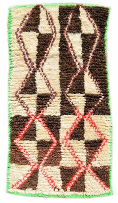 a brown and white rug with green trimmings on the bottom, in different colors