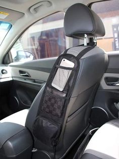 the interior of a car with a cell phone holder attached to the front passenger seat