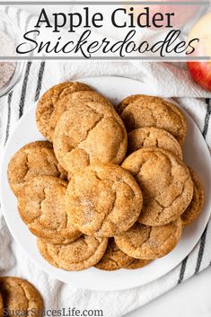 apple cider cookies on a white plate with apples in the background and text overlay