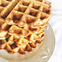 a stack of waffles sitting on top of a white plate