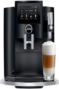 an espresso machine with a cup of coffee next to it on a white background