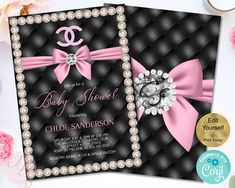 the baby shower is decorated with pearls, pearls and pink ribbon on black quilted fabric