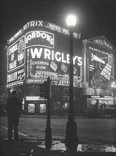 an old black and white photo of the wrigley's at night