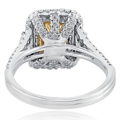 Elegant diamond engagement ring features a 1.00 carat radiant cut yellow diamond embraced by two trillion cut side diamonds in micro pave setting. The round cut diamonds line the double halo and the split shank adding an extra sparkle and fire to the ring. Handcrafted in 18-karat white gold. The total carat weight is 1.93 carats. The center diamond has been treated to enhance its beauty. Metal - 18k White Gold Metal Weight - 5.8 g Total Carat Weight - 1.93 Center Diamond Details: Shape - Radiant Luxury Yellow Diamond Halo Ring, Luxury Yellow Three-stone Jewelry, Luxury Yellow Hallmarked Rings, Luxury Yellow Sterling Silver Diamond Ring, Dazzling Yellow Diamond-cut Jewelry, Double Halo Engagement, Yellow Diamond Rings, Double Halo, Pave Setting