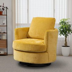 a yellow swivel chair sitting in front of a window next to a potted plant