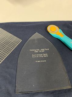 a pair of scissors sitting on top of a piece of cloth