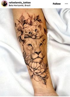 a woman's arm with a lion and flower tattoo on it