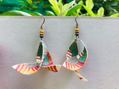 "These are 100% handcrafted earrings made by our artisans in Vietnam. The paper used is our traditional paper called \"Dó paper\", which is made in several steps from the bark of the \"Dó plant\". This paper is very strong and but extremely light, so you will feel like nothing hang on your ears! Very special feeling I promise! If you get the little rain, please dry it with a hairdryer. For big rain, maybe the best that you could save it in your pocket :) Each pair of earrings is unique and envir Handmade Artisan Wrap Earrings For Gifts, Multicolor Wrap Earrings As Gift, Handmade Multicolor Wrap Earrings For Gift, Fair Trade Dangle Earrings As Gift, Unique Fair Trade Earrings For Gift, Unique Fair Trade Earrings As Gift, Handmade White Wrap Earrings For Gift, Style Birthday, Social Enterprise