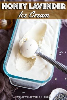 a scoop of ice cream in a glass dish with a spoon on the side and lavender sprinkles next to it