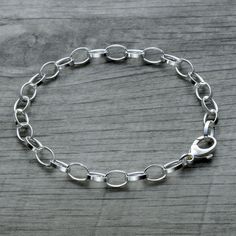 "Trust us your wrist needs our dainty classic sterling silver rolo link charm bracelet in 925 sterling silver. It's made in Italy and an absolutely stunning piece. So shiny and classy! Elevates your everyday outfits and will become a go-to jewelry piece since it matches with e-v-e-r-y-t-h-i-n-g! This petite bracelet is a perfect gift for a girl or teenager. It's also great for layering. Offered in 925 sterling silver, 18k rose gold vermeil and 18k yellow gold vermeil. All finishes use solid 925 sterling silver as base material. The vermeil gold finish is 5 times thicker than regular gold plating and is the best quality jewelry other than solid gold - a perfect combination of quality and value. Features: - Sterling silver rolo chain - Made in Italy - Bracelet weight is 4.9grams for 7.5\" le Classic Charm Bracelet With Extender As Gift, Everyday Charm Bracelet With Rolo Chain, Everyday Silver Bracelet With Rolo Chain, Silver Rolo Chain Bracelet For Everyday, Silver Charm Bracelet With Oval Link, Sterling Silver Link Bracelets With Rolo Chain, Sterling Silver Oval Link Charm Bracelet, Silver Oval Link Charm Bracelet, Silver Minimalist Oval Link Charm Bracelet