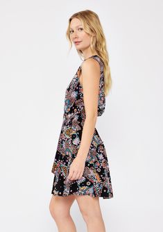 A sleeveless belted mini dress in a black and mixed floral print. Mixed floral print Relaxed fit Sleeveless Mini length Button-front Ruffle-trimmed tiered skirt V-neckline Adjustable attached d-ring belt Smocked elastic waist Fall mini dress A versatile sleeveless mini dress that will take you from day to night with ease. Designed in a classic mixed floral print, with a ruffle-trimmed tiered skirt, a v-neckline, and a smocked elastic waist for added definition. Elevated with a charming d-ring be Multicolor Sleeveless Ditsy Floral Dress, Black Bohemian Sleeveless Dress With Floral Print, Black Floral Print Sundress Sleeveless, Black Floral Print Sleeveless Sundress, Black V-neck Dress With Paisley Print, Sleeveless Floral Print Patterned Mini Dress, Patterned Floral Print Sleeveless Mini Dress, Black Sleeveless Dress With Ditsy Floral Print, Patterned Floral Print Sleeveless Dress