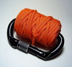 a spool of orange colored rope on a black hook