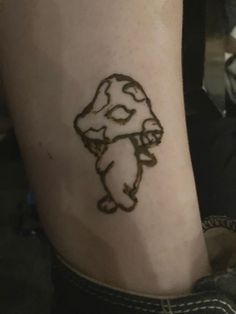 a tattoo on the leg of a person with a bear drawn on it's arm