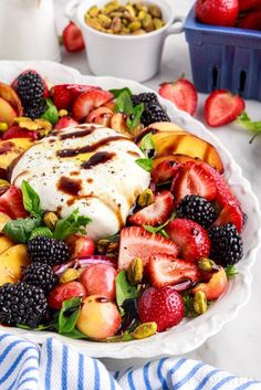 a white plate topped with fruit and whipped cream