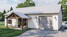 a small white house with a porch and covered patio in the middle of a grassy area