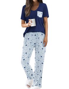 a woman wearing pajamas and holding a cup