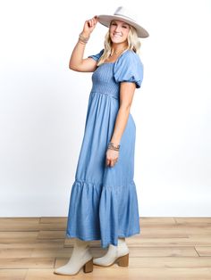 Add a touch of whimsy to your wardrobe with our Locked In Smocked Puff Sleeve Midi Dress. The denim blue midi dress features a smocked top and playful puff sleeves. Perfect for a day out or a special occasion, this dress is sure to turn heads and make a statement! Danielle is 5'7" and wearing a Medium. Blue Midi Dress With Smocked Bodice And Puff Sleeves, Blue Smocked Dress With Puff Sleeves, Blue Smocked Puff Sleeve Dress, Blue Midi-length Puff Sleeve Dress With Smocked Bodice, Blue V-neck Smocked Dress, Puff Sleeve Midi Dress, Smocked Top, Short Denim Skirt, Blue Midi Dress