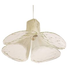 a white flower shaped light hanging from a ceiling