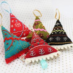 four christmas ornaments are sitting on a table