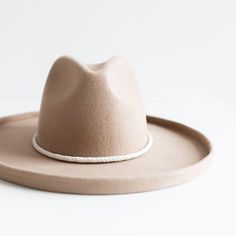 This thick, intricately braided leather rope band features elegant gold hardware in a traditional bolo style, enhancing the look of any hat! This hat band is adjustable and one size fits all. Western Braided Fedora With Short Brim, Western Style Fedora With Short Brim And Braided Detail, Braided Short Brim Hat For Rodeo, Braided Wide Brim Hat For Ranch, Rodeo Hats With Braided Short Brim, Western Braided Fedora Hats, Rodeo Braided Hat With Short Brim, Braided Western Fedora Hats, Wide Brim Braided Hat For Ranch